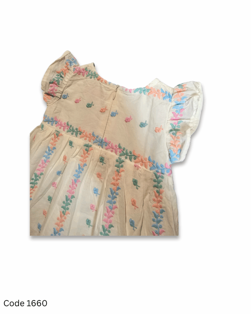White sleeveless girl dress with flutter sleeves, full embroidery, soft inner lining, and back zip closure