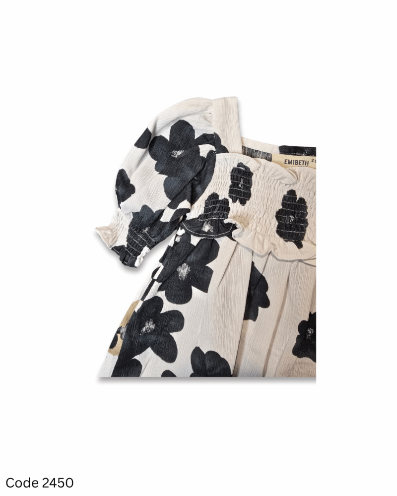 Off-white toddler dress with black and brown floral prints, elastic long sleeves, and elastic yoke
