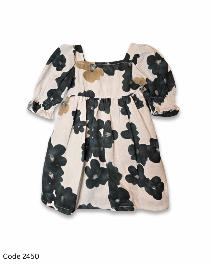 Off-white toddler dress with black and brown floral prints, elastic long sleeves, and elastic yoke
