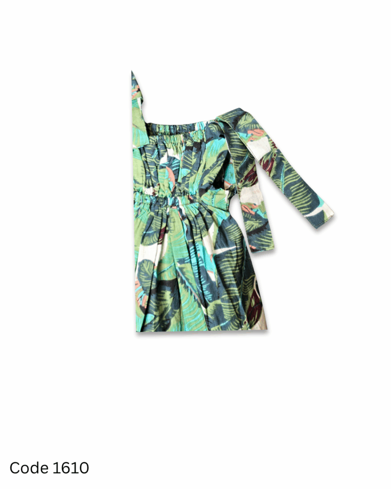 Girl wearing a green leaves print dress with tie-shoulder straps and elastic yoke
